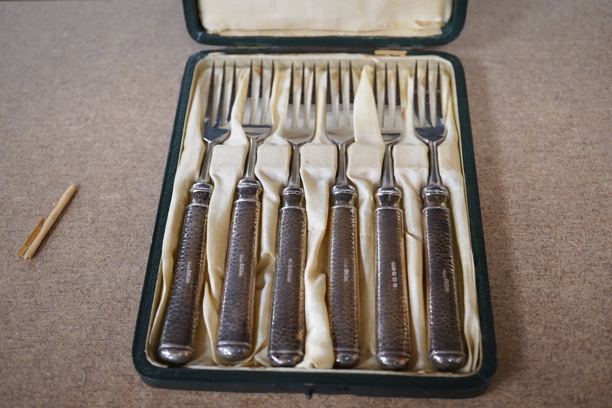 A cased set of six Edwardian silver handled pastry forks by Liberty & Co, with later? steel tines, Birmingham, 1902, 14.8cm, in Liberty & Co box. Condition - fair